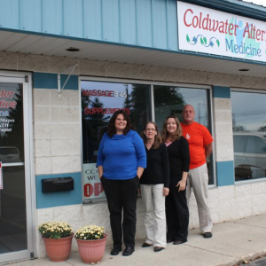 a group of people standing in front of a shop